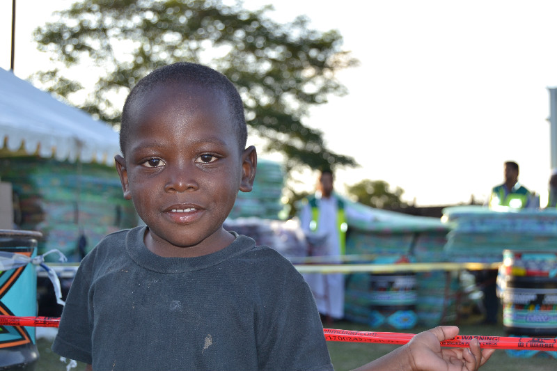 A young beneficiary of the distribution- the number of children and infants at the camp reaches over a hundred placing these delicate individuals at serious risk